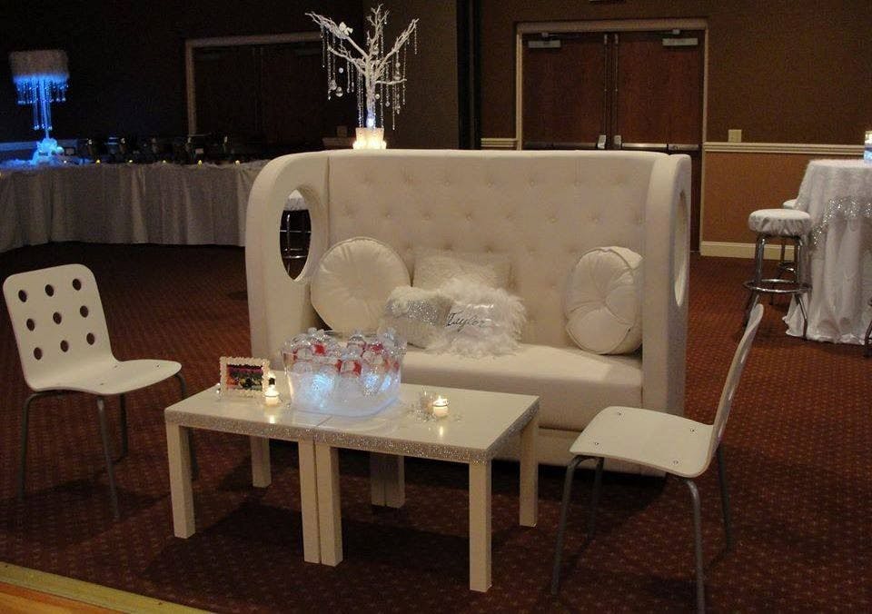 a living room with a couch a table and chairs