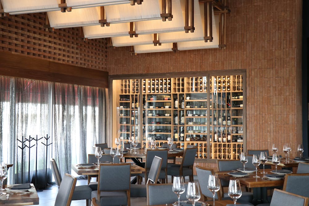 a dining room filled with furniture and a large window