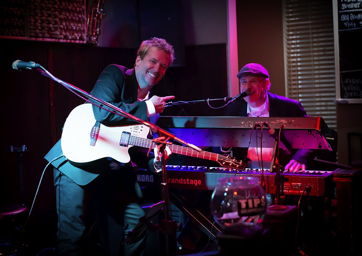 a man on a stage playing instruments