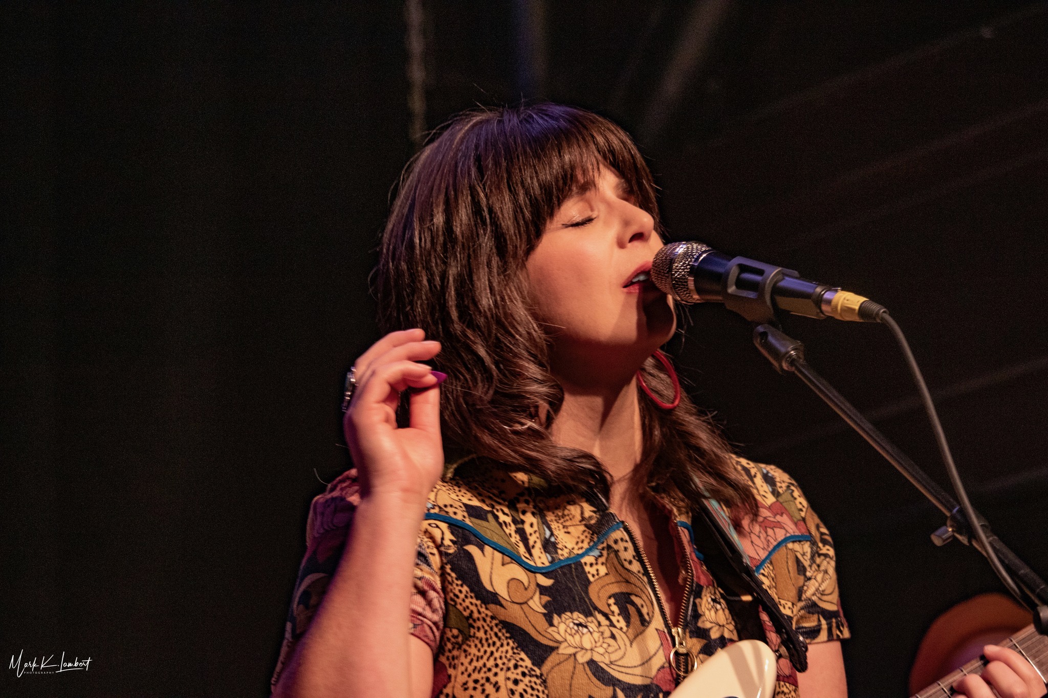 a woman singing into a microphone