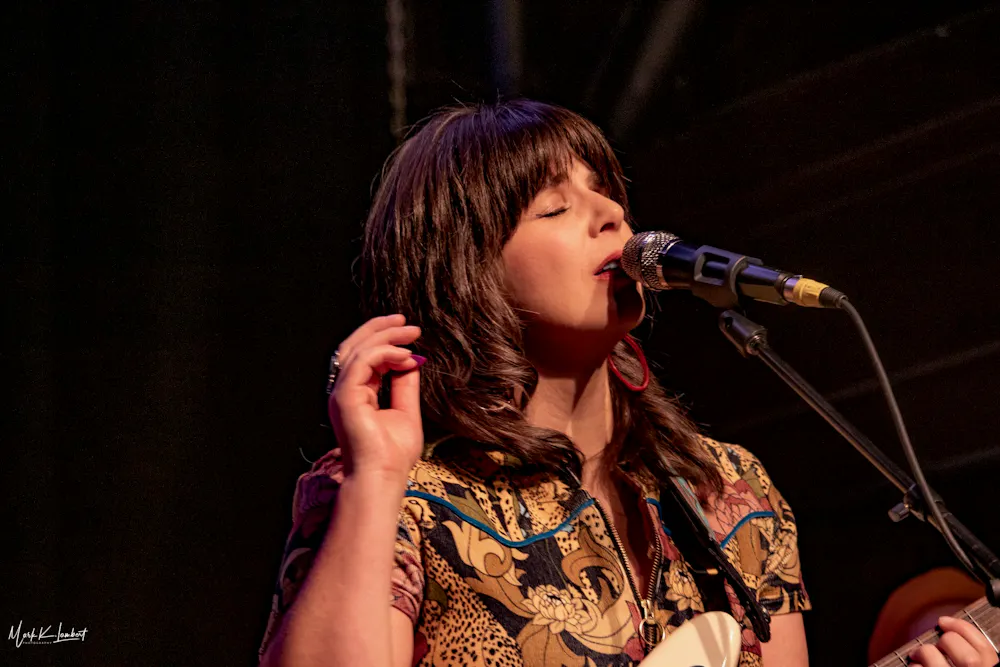 a woman singing into a microphone