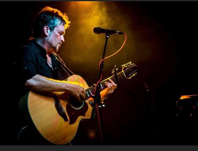 a man holding a guitar