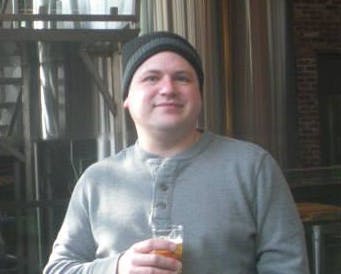 a man holding a wine glass posing for the camera