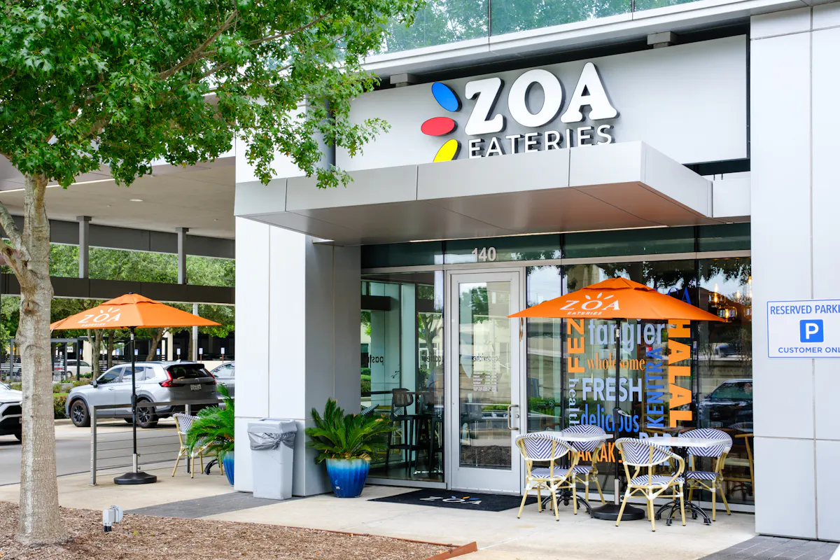 a restaurant with tables and umbrellas