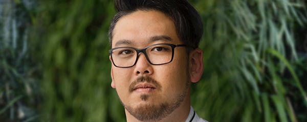 a man wearing glasses and looking at the camera