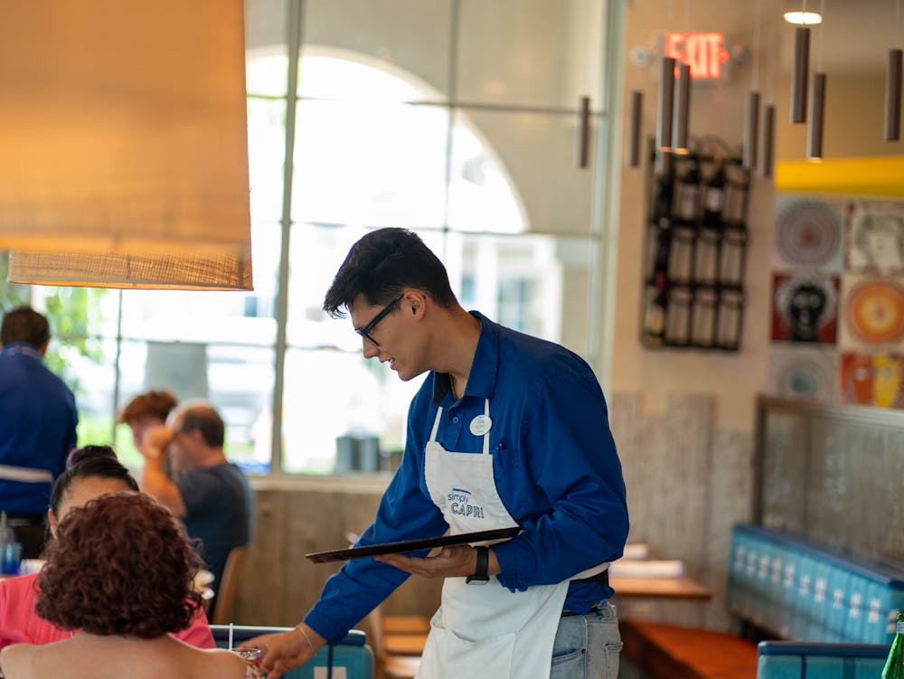 a group of people standing around a table