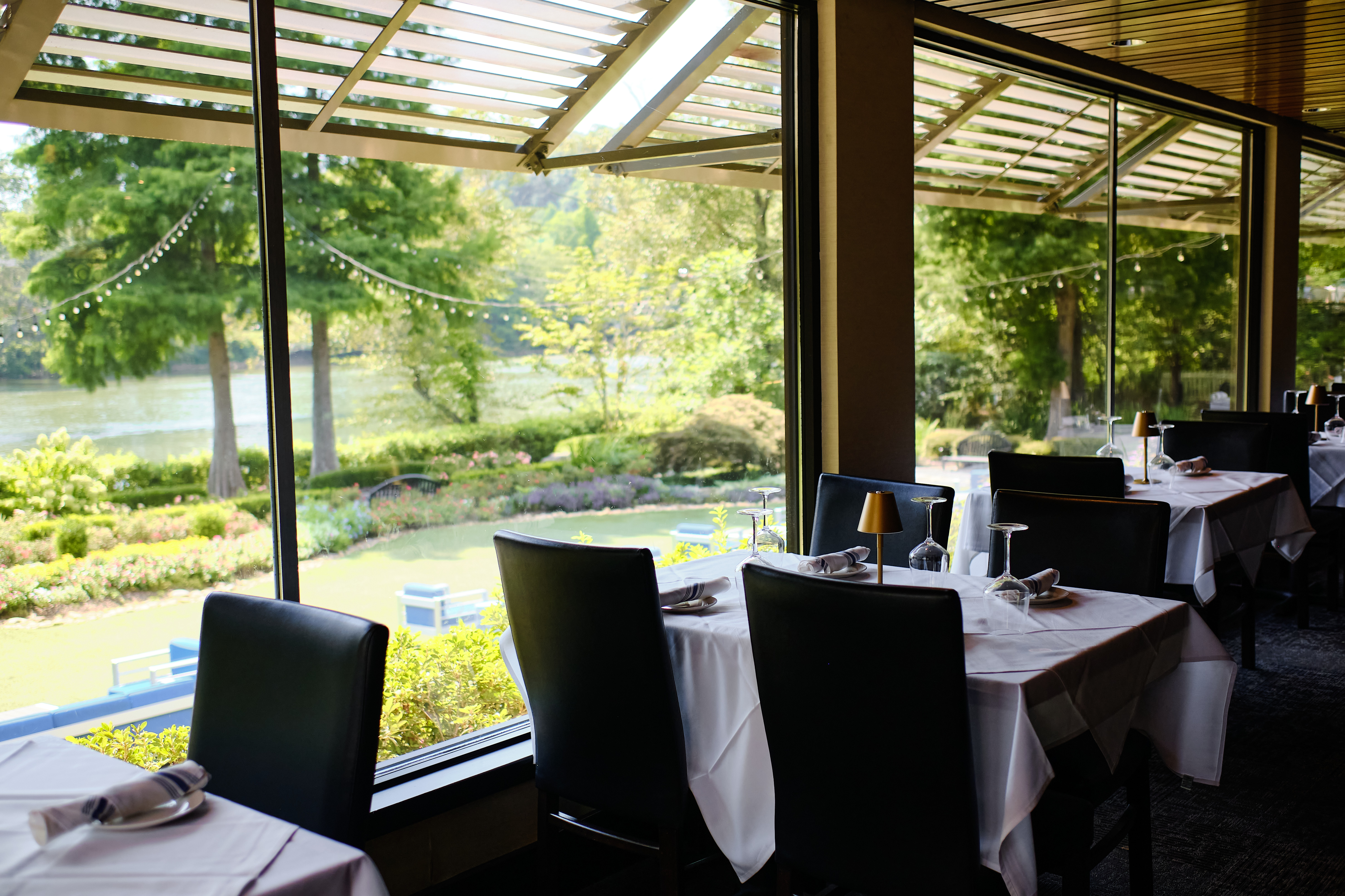 A restaurant interior featuring tables and chairs