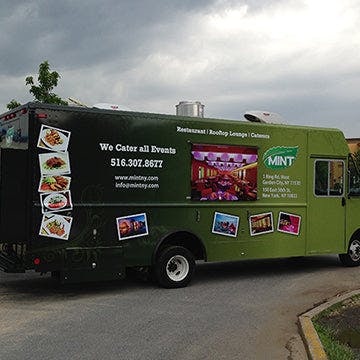 a green truck parked in a parking lot
