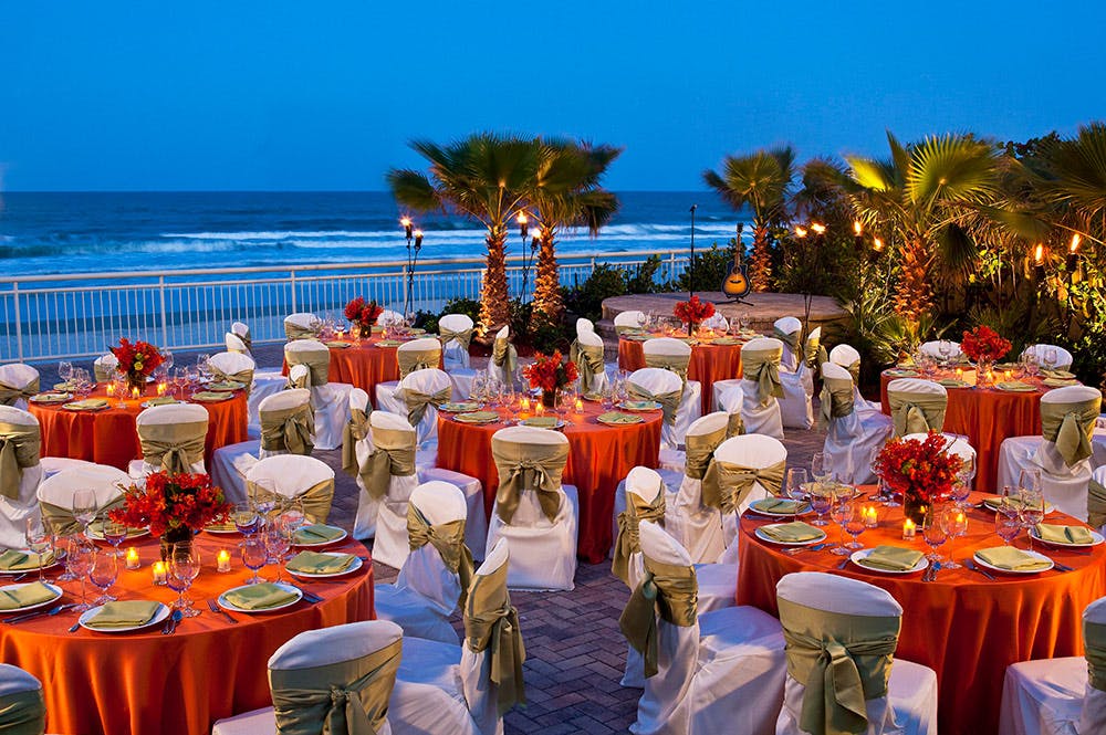 a group of people sitting at a dinner table umbrella