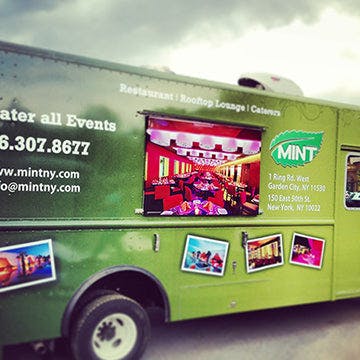 a green truck parked in a parking lot