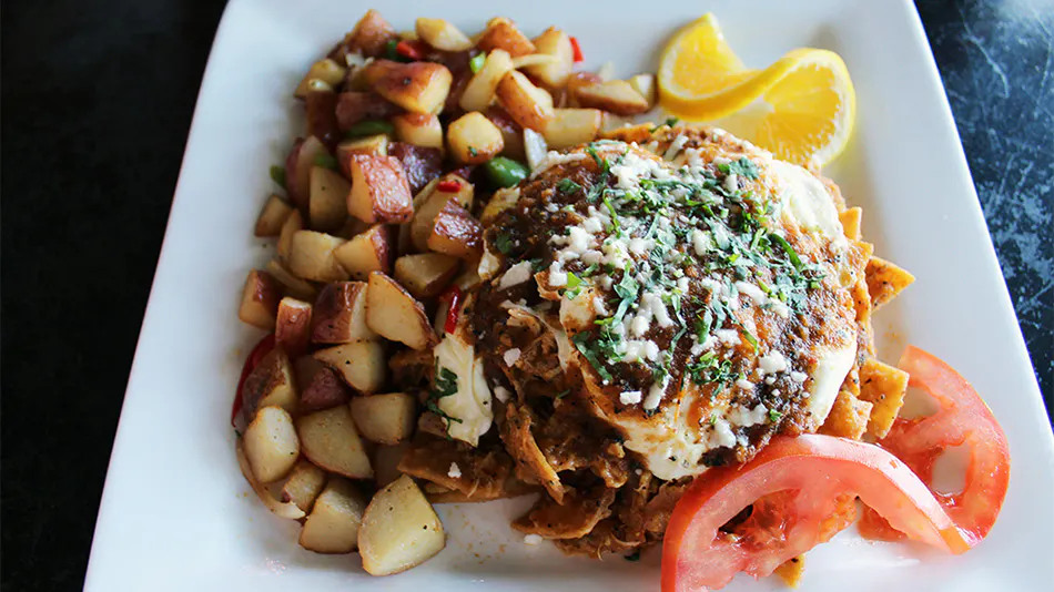Malibu breakfast place serving plate of potatoes and chilaquiles.