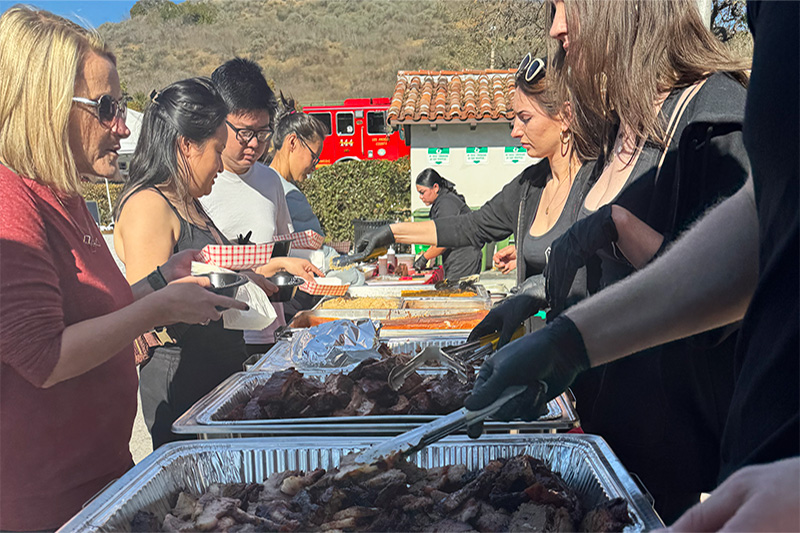 Staff giving steak to guests as part of our Westlake Village barbecue catering services for weddings.