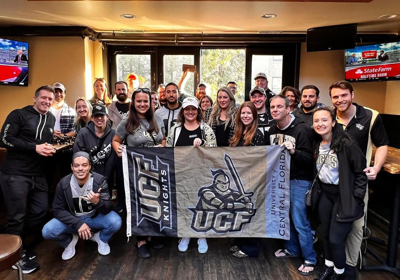 a group of people cheering upstairs 