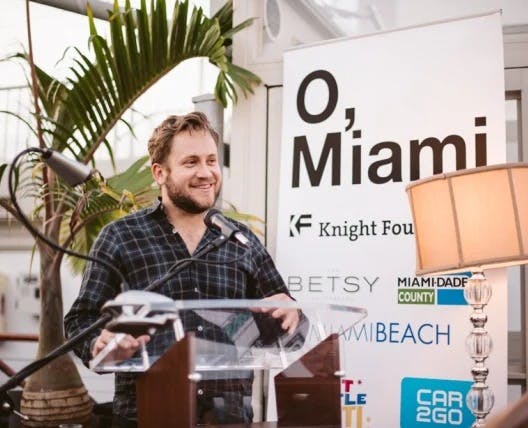 P. Scott Cunningham holding a sign