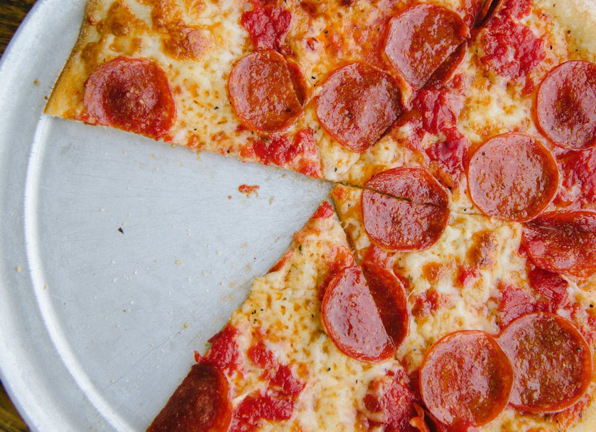 a close up of a slice of pepperoni pizza on a plate
