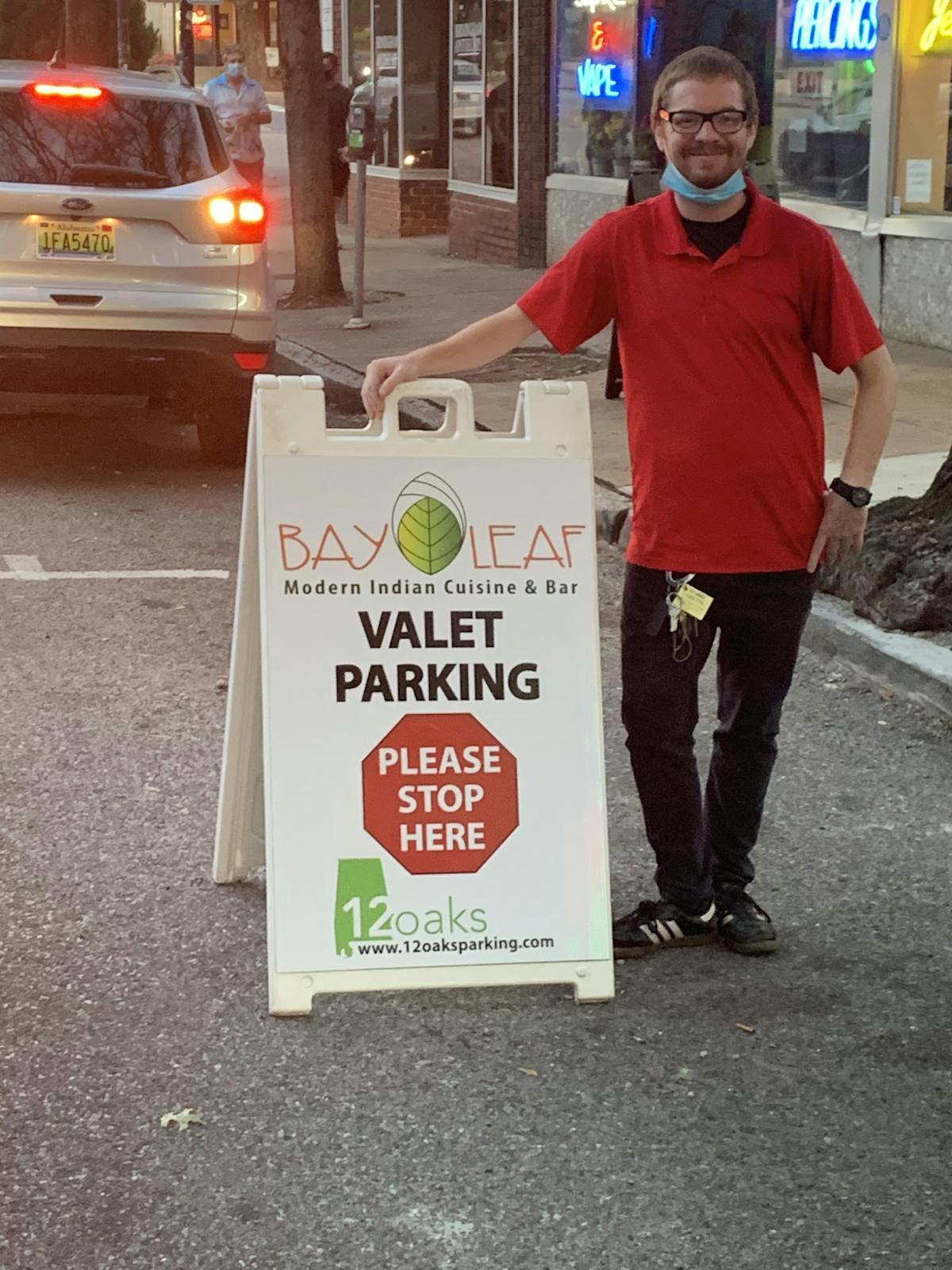 a man standing in front of a sign