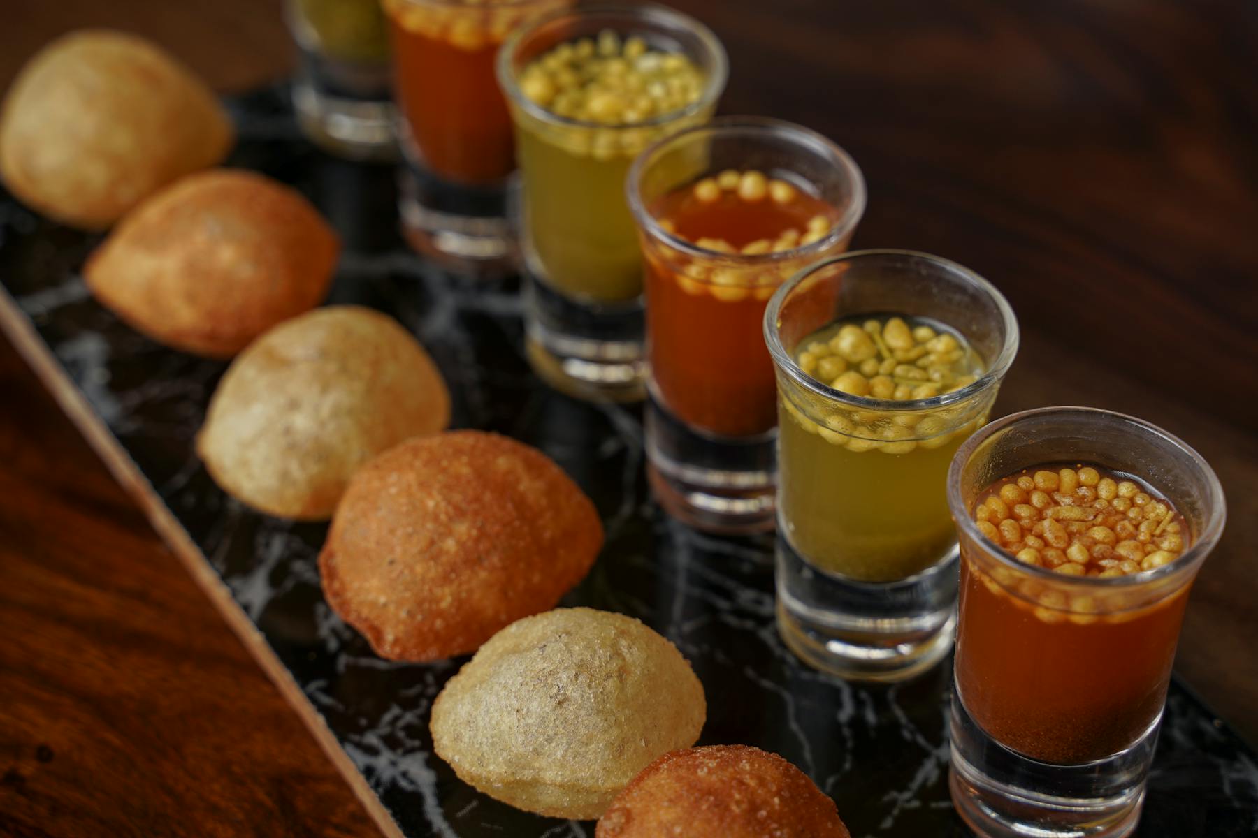 food on a table next to a glass of orange juice