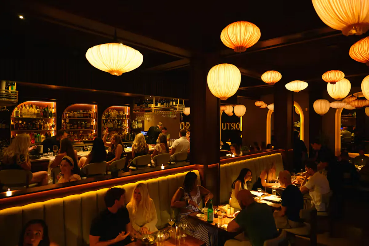 a group of people sitting at tables in a restaurant