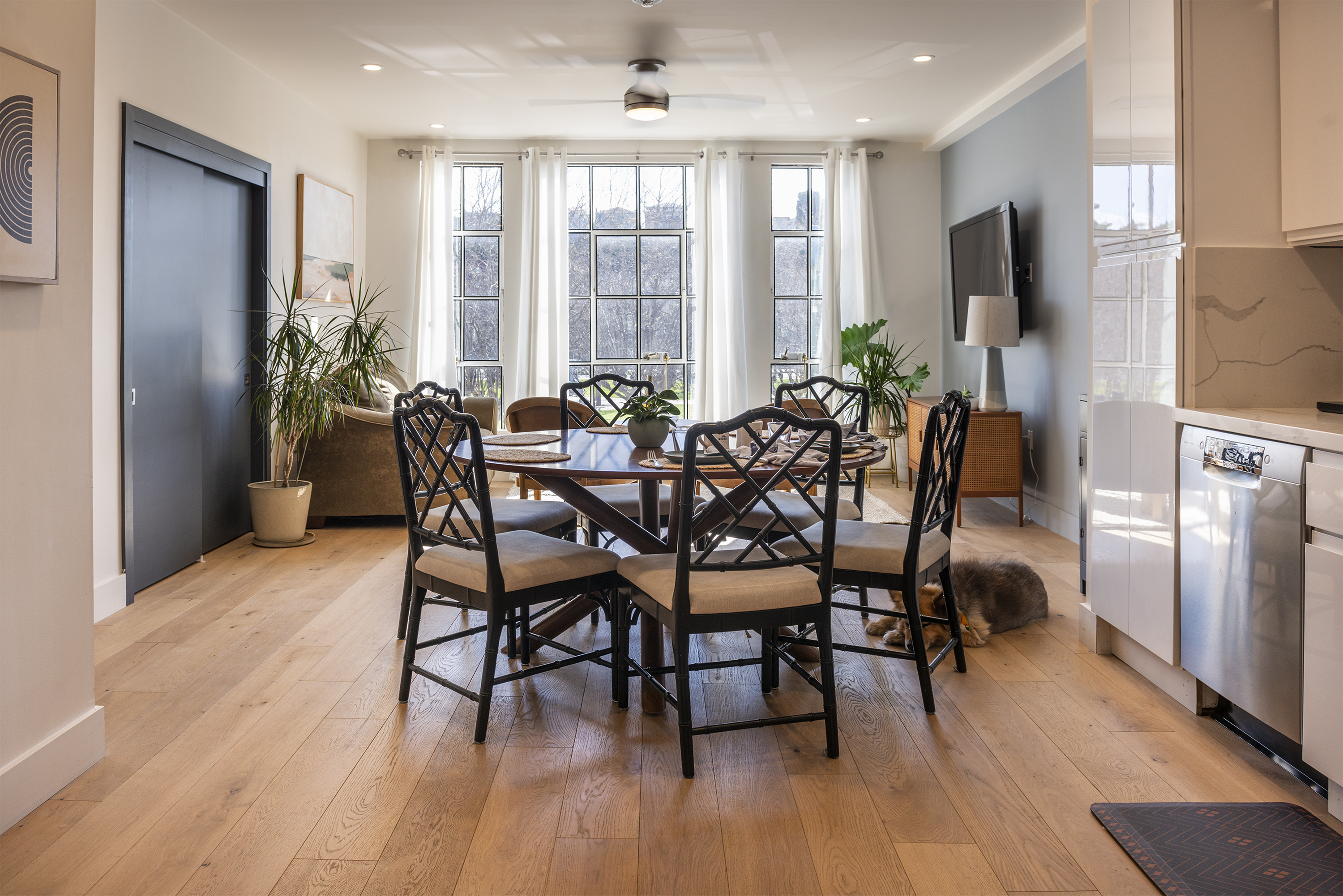 a living room filled with furniture and a large window