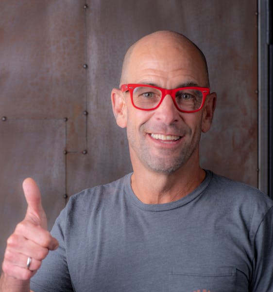 Victor Rallo wearing glasses and smiling at the camera
