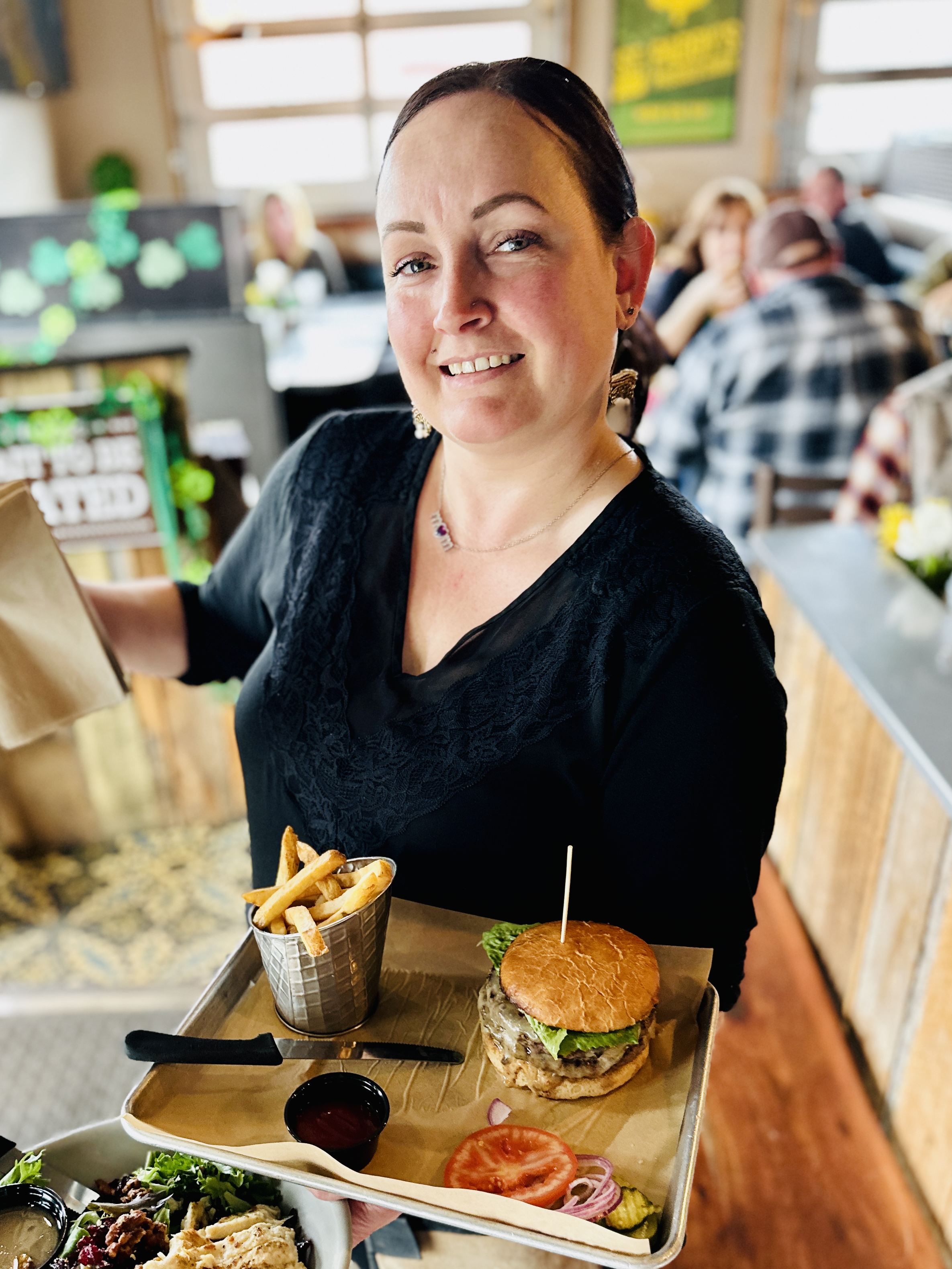 a woman sitting at a table with a plate of food