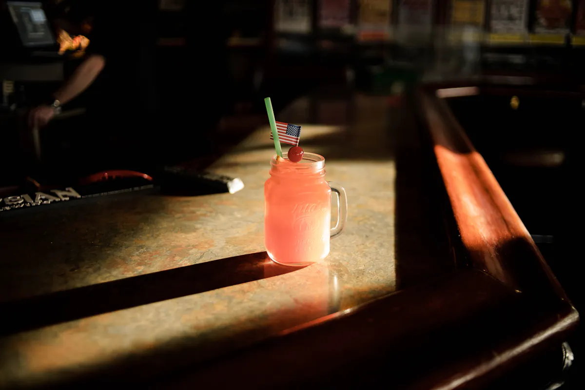 a glass bottle sitting on top of a wooden table