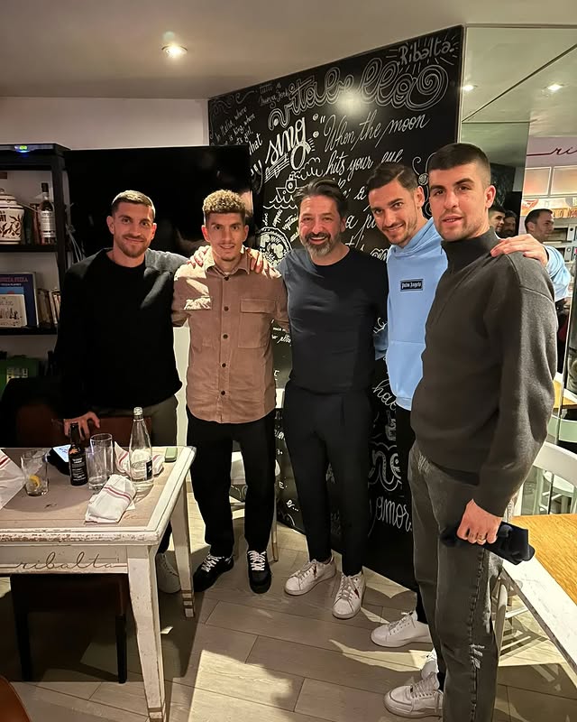 a man standing in front of a brick building