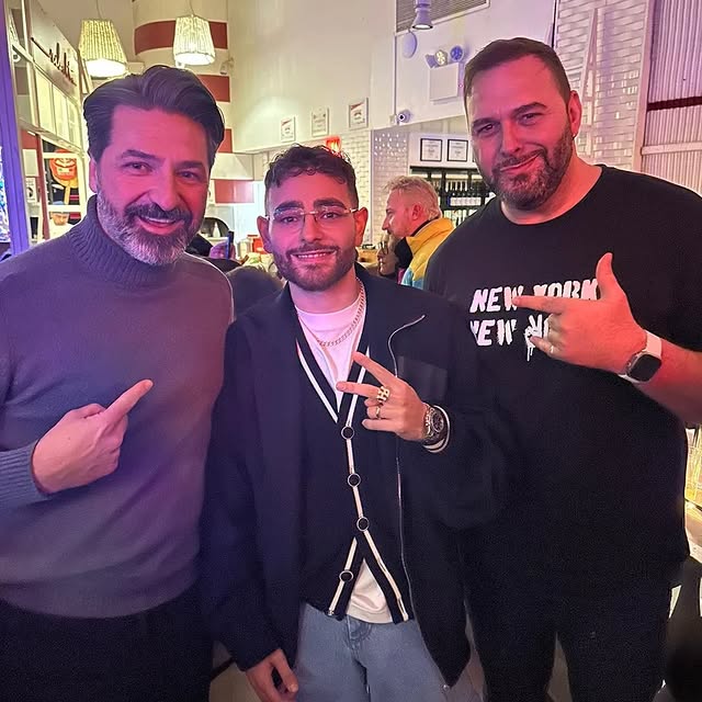 a man standing in front of a brick building