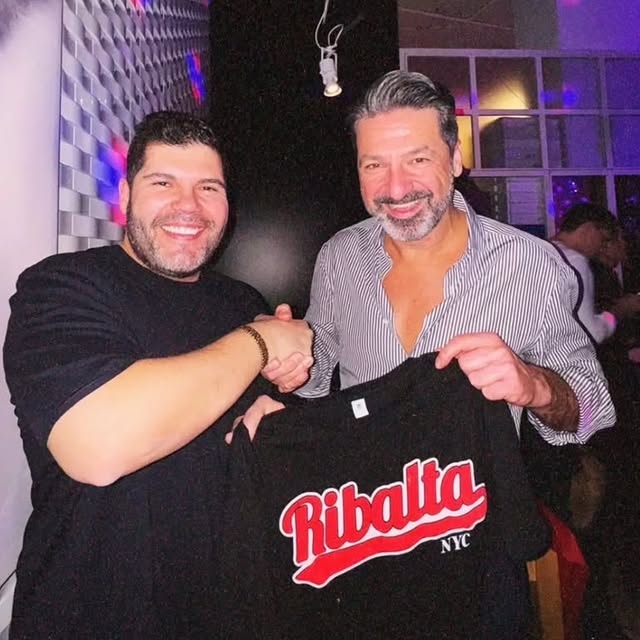 a man standing in front of a brick building