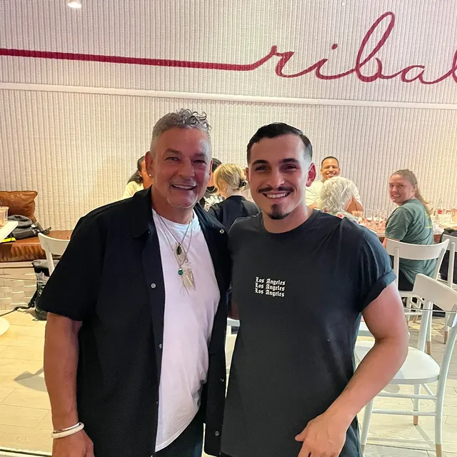a man standing in front of a brick building