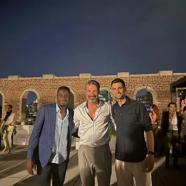 a man standing in front of a brick building