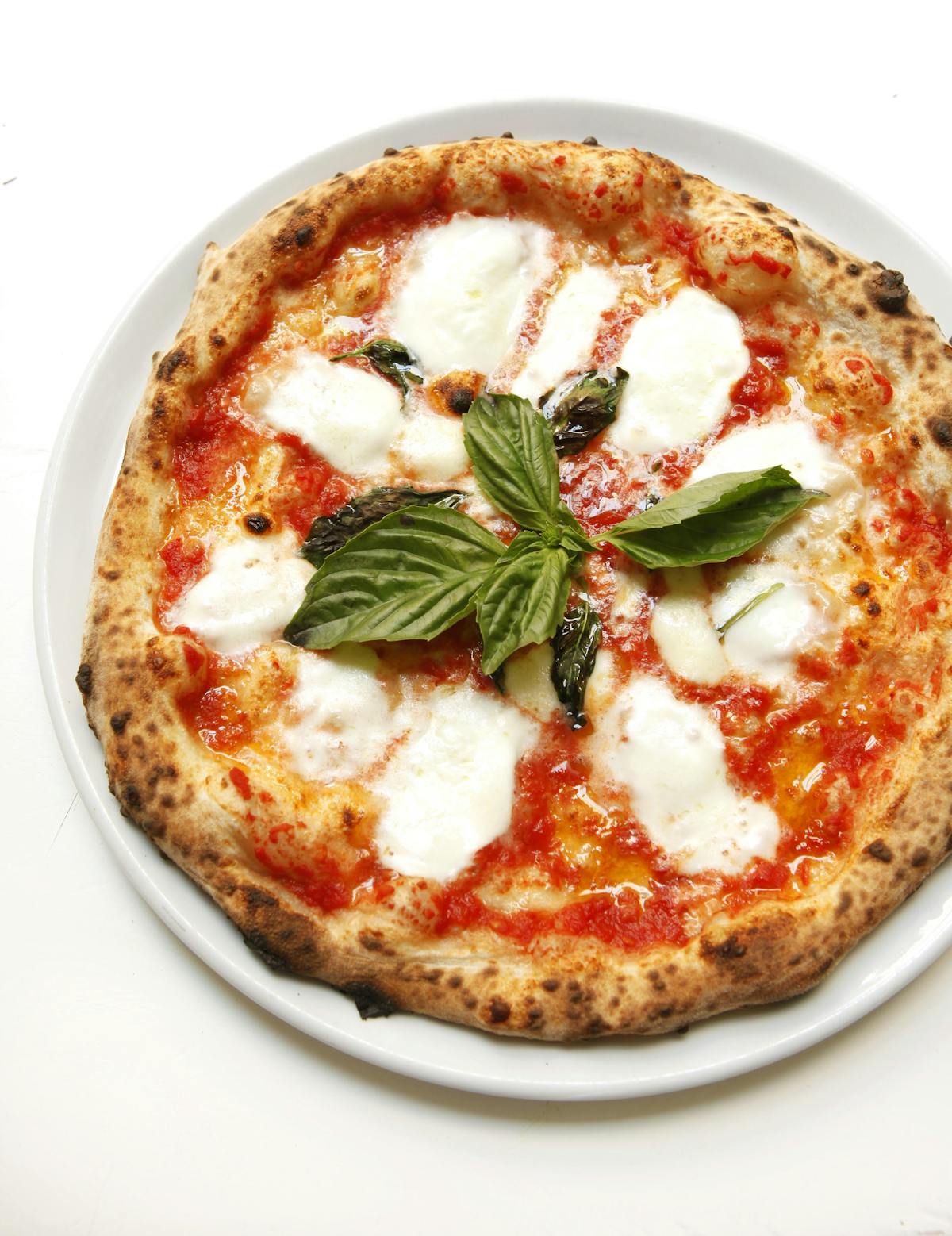 a pizza sitting on top of a plate of food