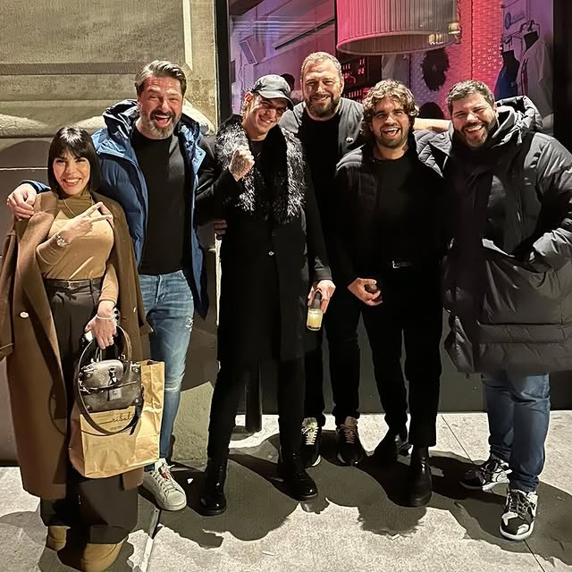 a man standing in front of a brick building