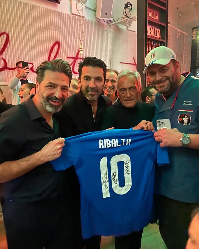a man standing in front of a brick building
