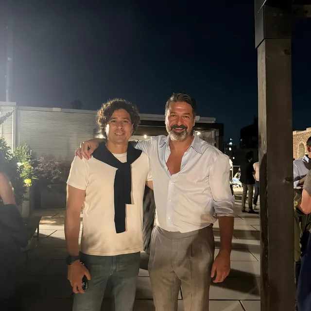 a man standing in front of a brick building