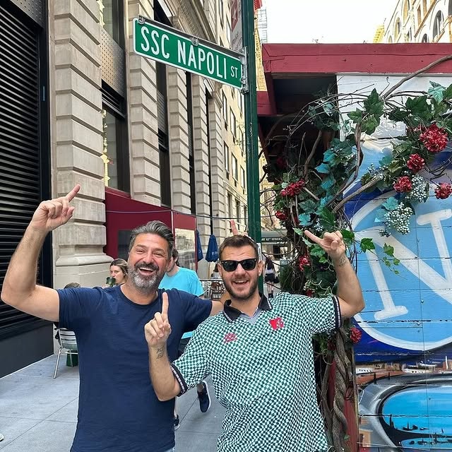 a man standing in front of a brick building