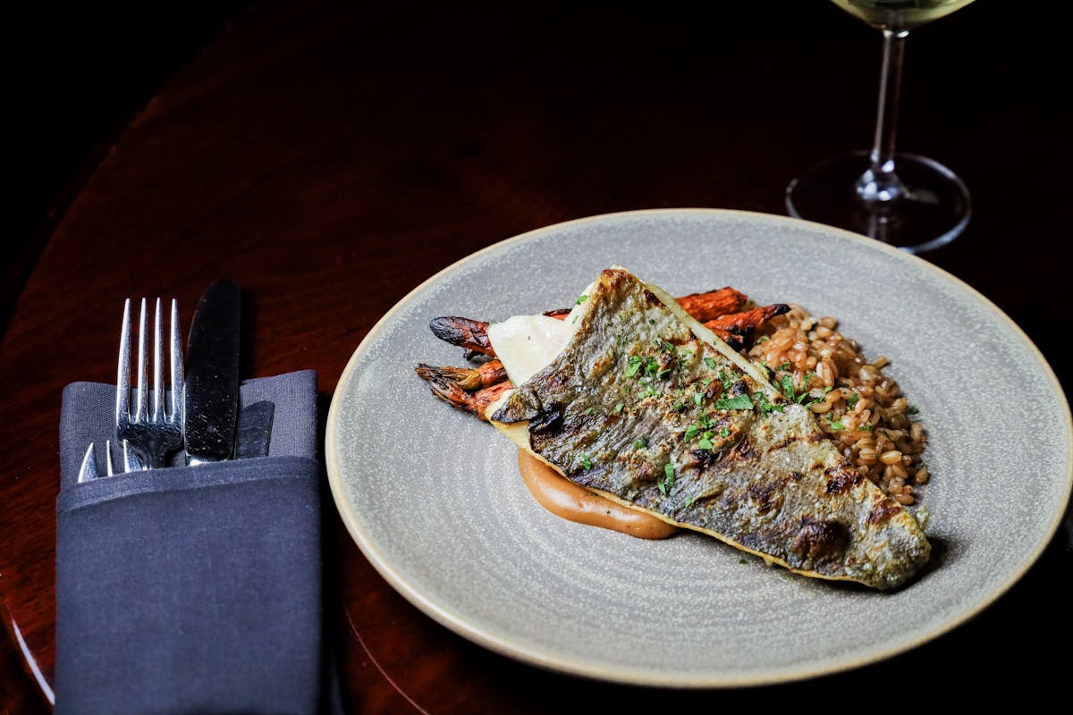 a plate of food and a glass of wine