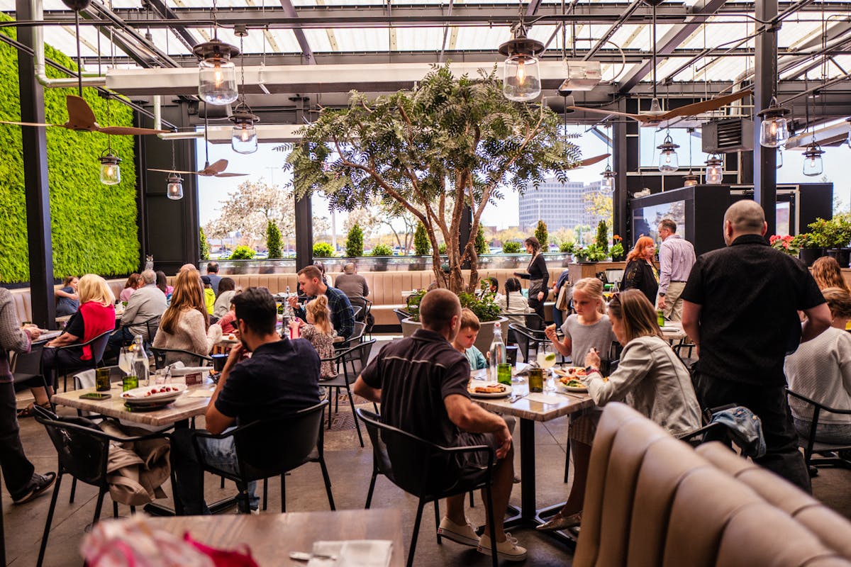 a group of people sitting at a table in a restaurant