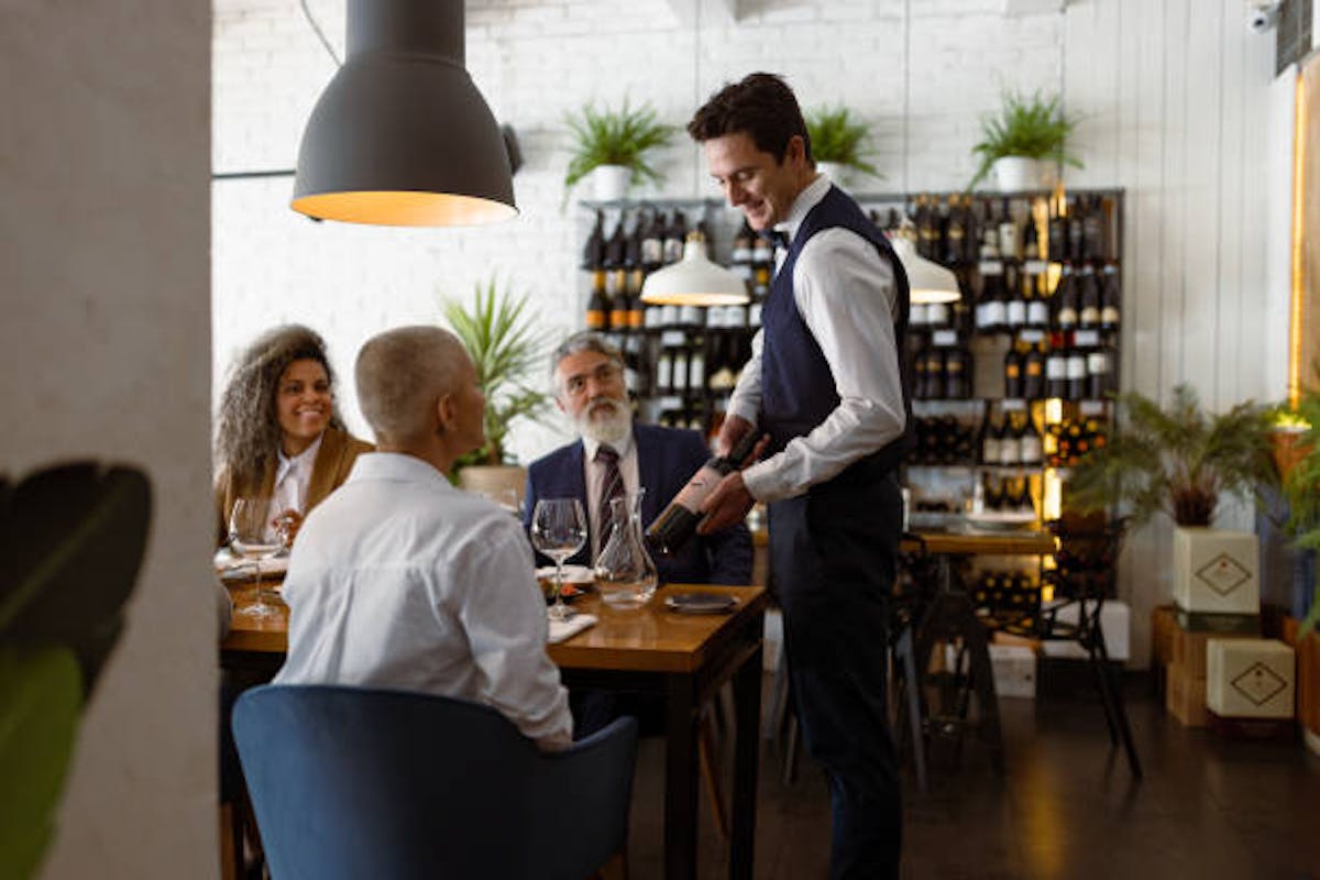 a group of people sitting at a table in a restaurant