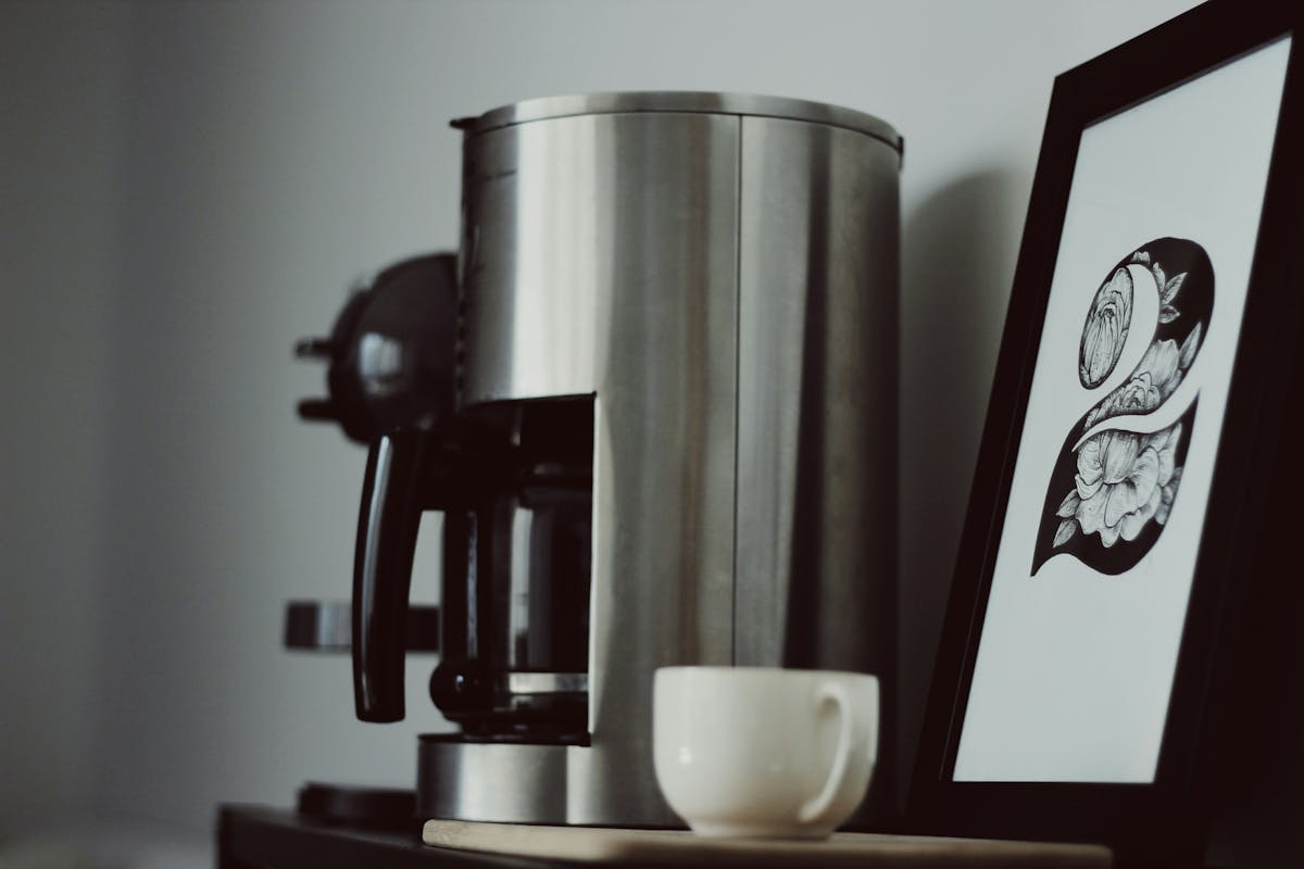 A coffee maker and a framed picture