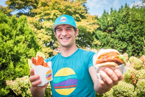 a person holding a hot dog