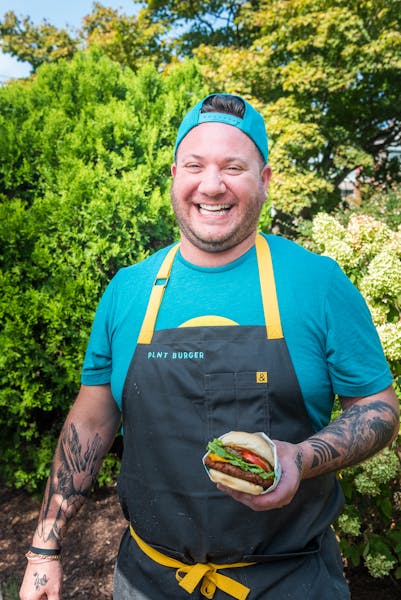 a smiling man in a blue shirt
