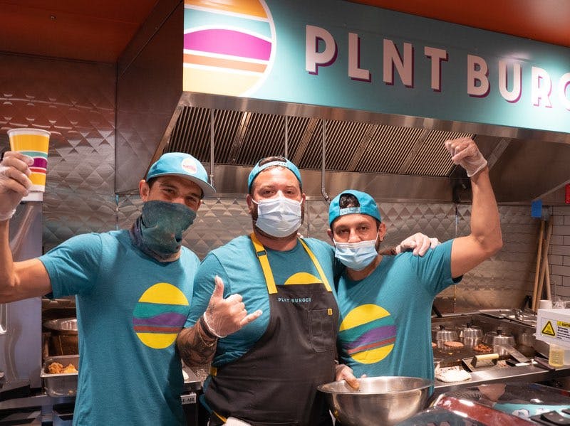 a group of people standing in a kitchen