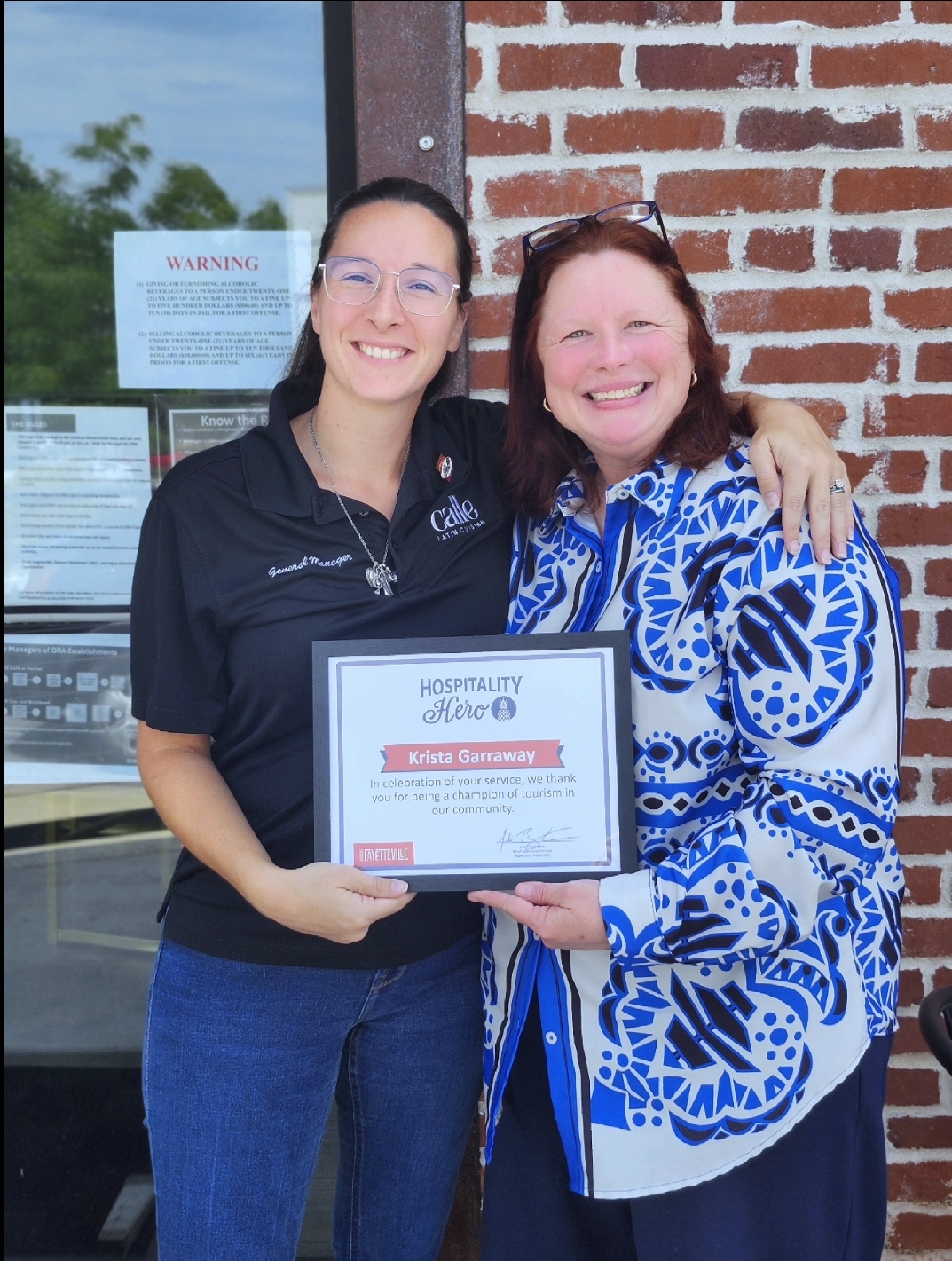 a person holding a sign posing for the camera