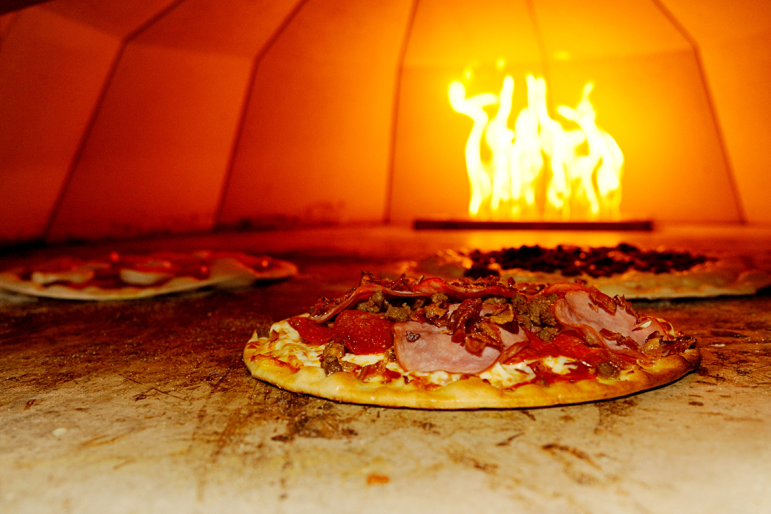 a pizza sitting on top of a wooden table