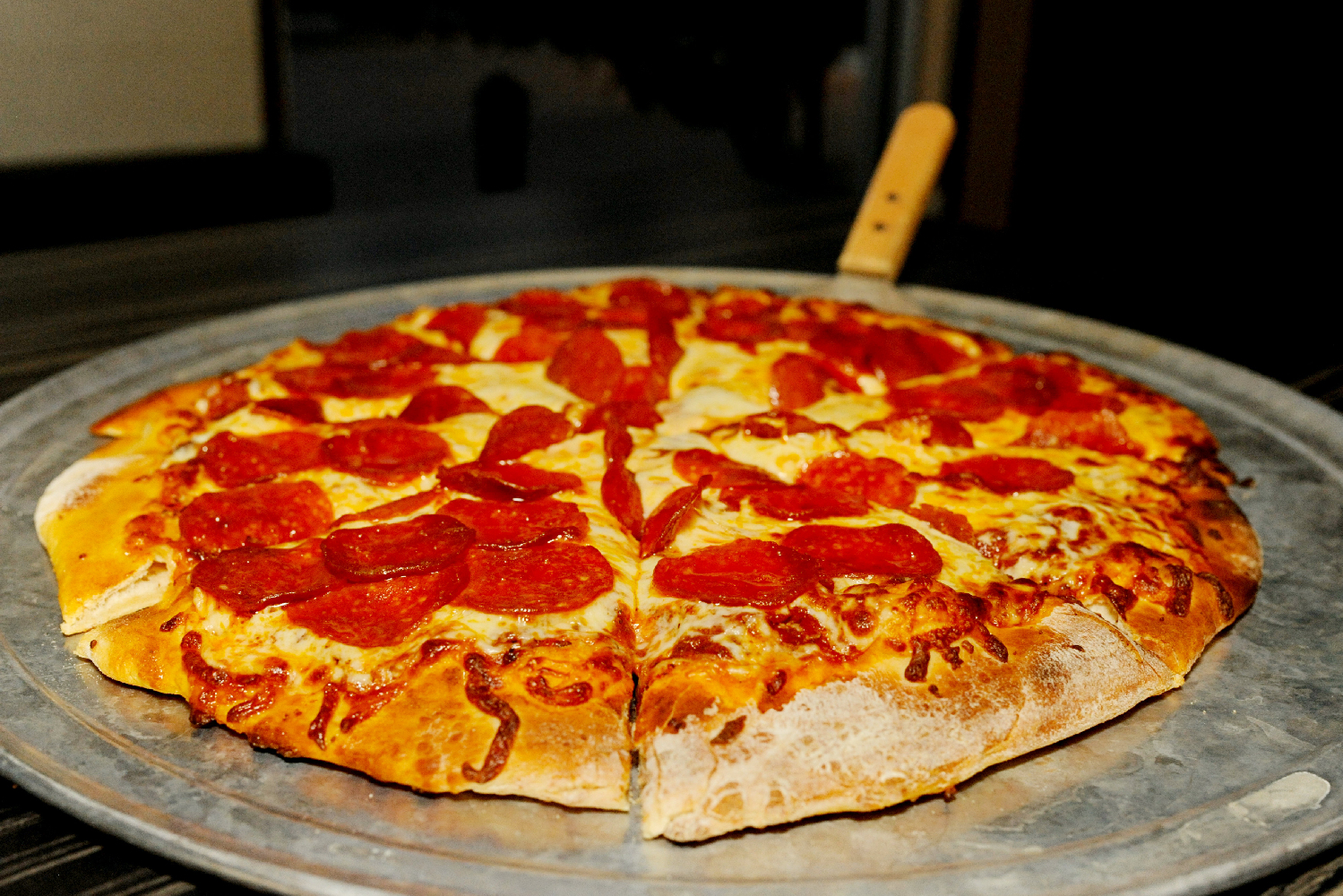 a pizza sitting on top of a pan on a table