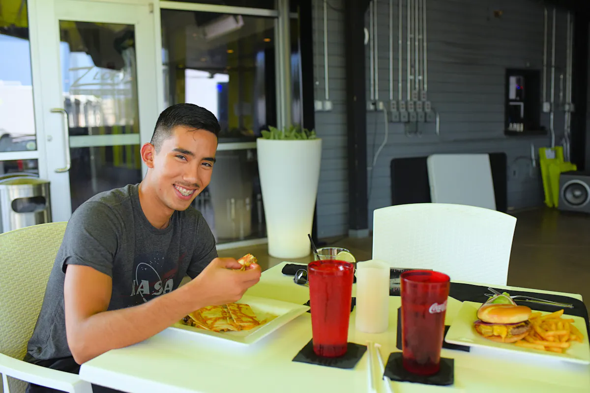 a person sitting at a table with food