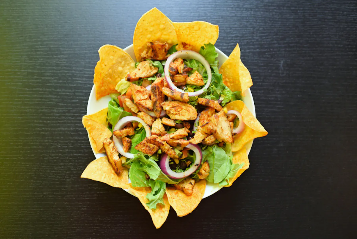 a sandwich with lettuce and a chip