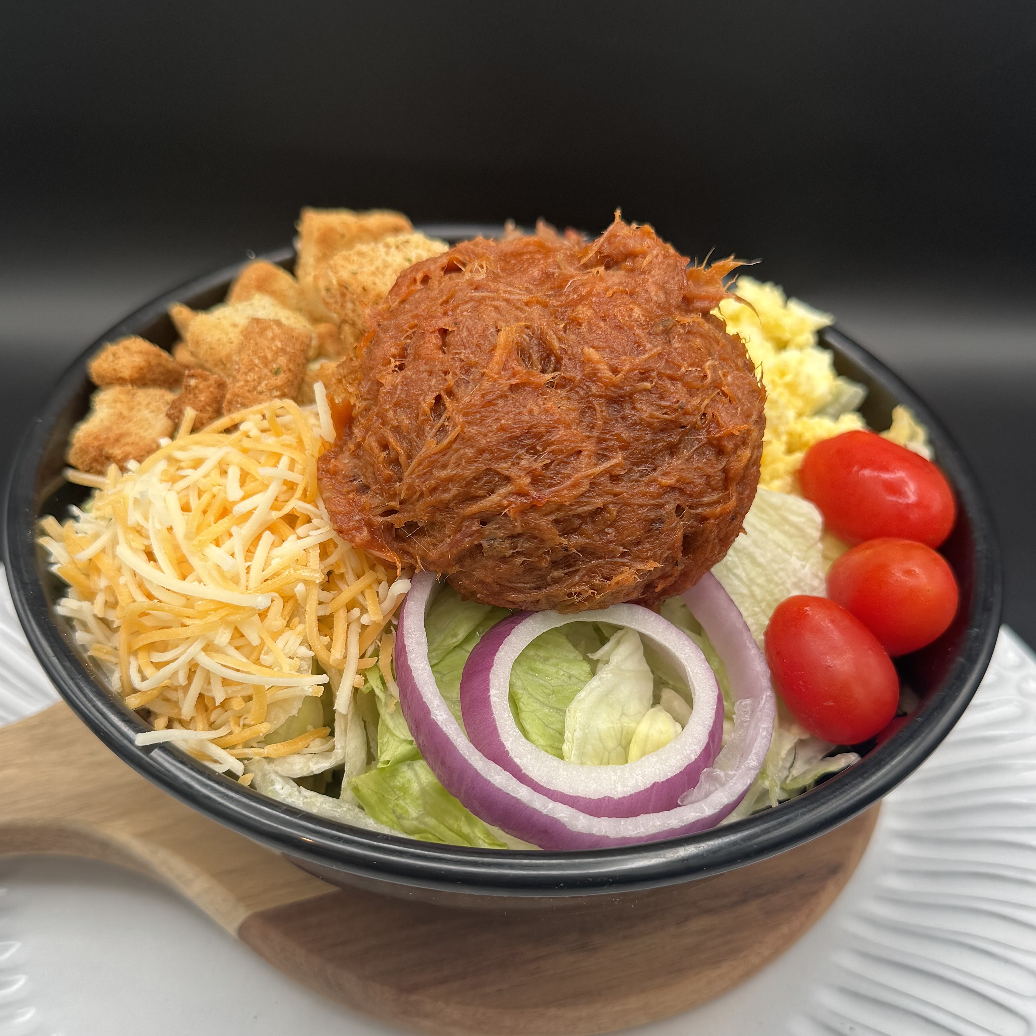 a bowl of salad with meat and vegetables