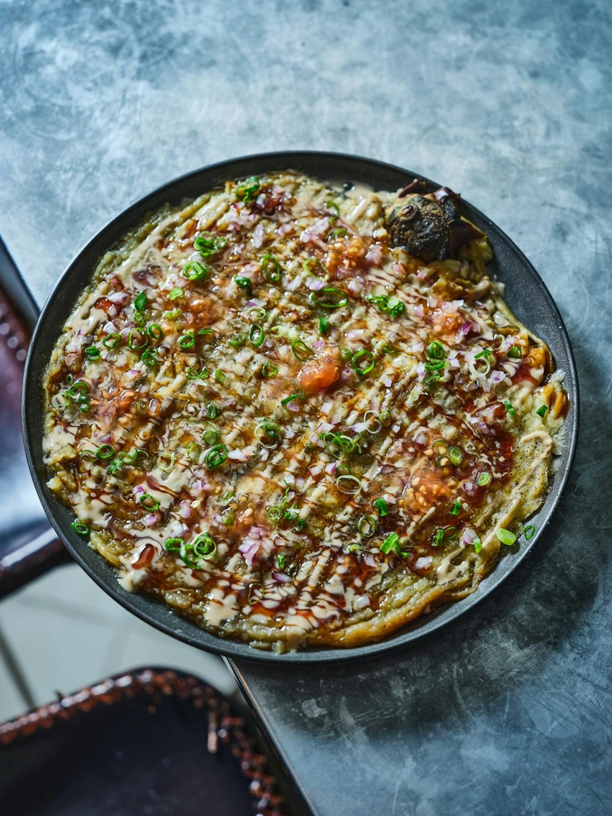 a pizza sitting on top of a metal pan